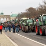 Berlin,,Germany,December,18.,2023,Farm,Tractors,With,The,Brandenburg